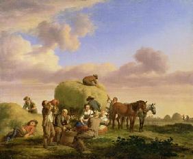 Haymakers resting in a field
