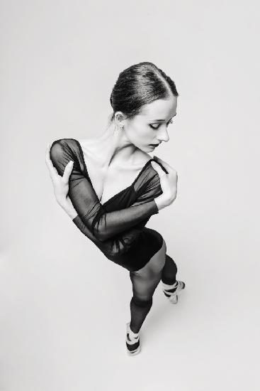 Porträt einer Ballerina in einem schwarzen Body,Draufsicht,die die Arme um die Schultern legt