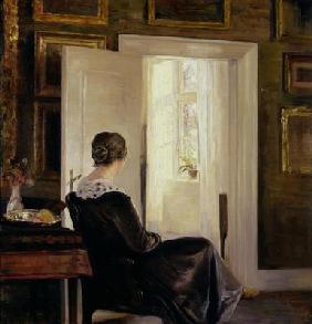 A woman seated near a door 19th