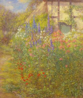 Lilien,  Rittersporn und Mohnblumen im Garten des Künstlers Cottage in Ashton-under-Hill in der Nähe