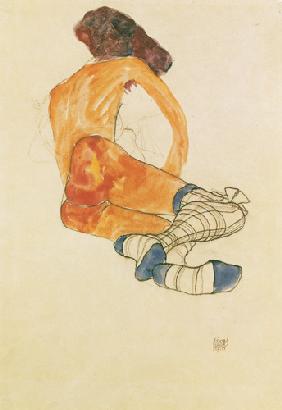 Sitzender weiblicher Akt mit blauem Strumpfband, vom Rücken gesehen 1910