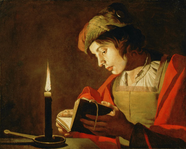 Junger Mann, lesend im Kerzenschein von Matthias Stomer