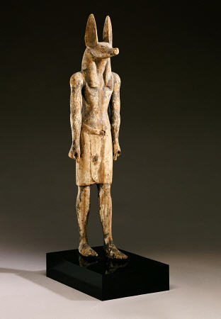 An Egyptian Wood Figure Of A Jackal-Headed Deity von 