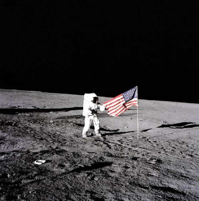 Apollo 12 Astronaut Charles Pete Conrad stands beside the United States flag after is was unfurled o von 