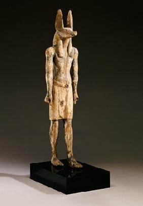 An Egyptian Wood Figure Of A Jackal-Headed Deity