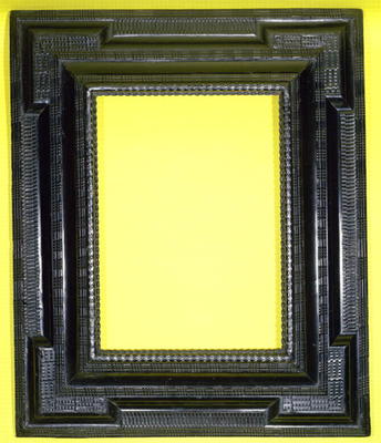 Alpine 17th century carved and ebonised frame with a projecting plane, inset extended corners and va von 