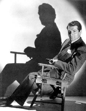 English Actor Laurence Olivier seated on a chair's director c. 1939