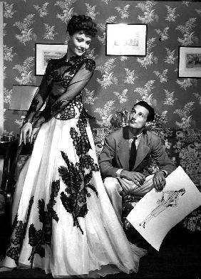 fashion designer Oleg Cassini showing his drawings to Gene Tierney to show her the clothes for film  in 1941
