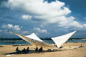 Fishermen mending their nets under shade of triangular sails, Gopalpur (photo) 