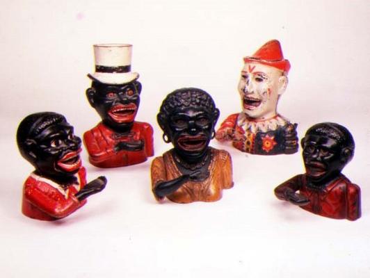 Group of Mechanical cast iron money banks. Left to right: Jolly Nigger with Butterfly Tie, Jolly Nig von 