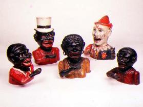 Group of Mechanical cast iron money banks. Left to right: Jolly Nigger with Butterfly Tie, Jolly Nig 19th
