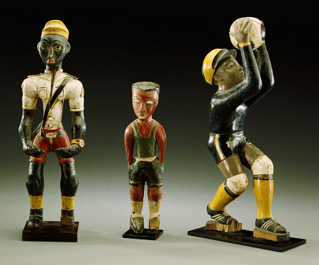 Three Male Carved Figures, One Wearing An Official''s Uniform, The Other Two In Sports Gear von 