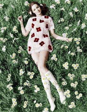 Young model Biddy Lampard in the grass wearing a short dress inspired by Courreges colourized docume August 196