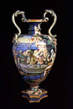 Maiolica urn with two handles in the shape of serpents, the body decorated with an al fresco banquet mid 16th c